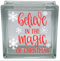 Glass block with 'believe in the magic of Christmas' text and snowflakes on a white background