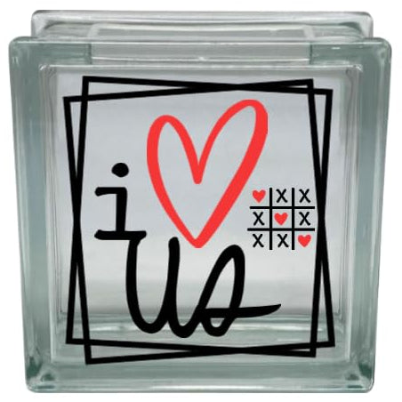 Clear glass block with 'i ❤️ us' text and heart design on a white background