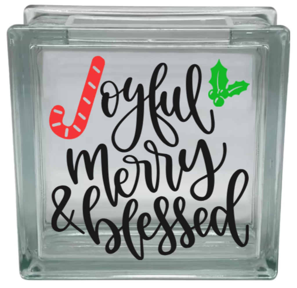 Decorative glass block with 'Joyful Merry & Blessed' text and Christmas graphics on a white background