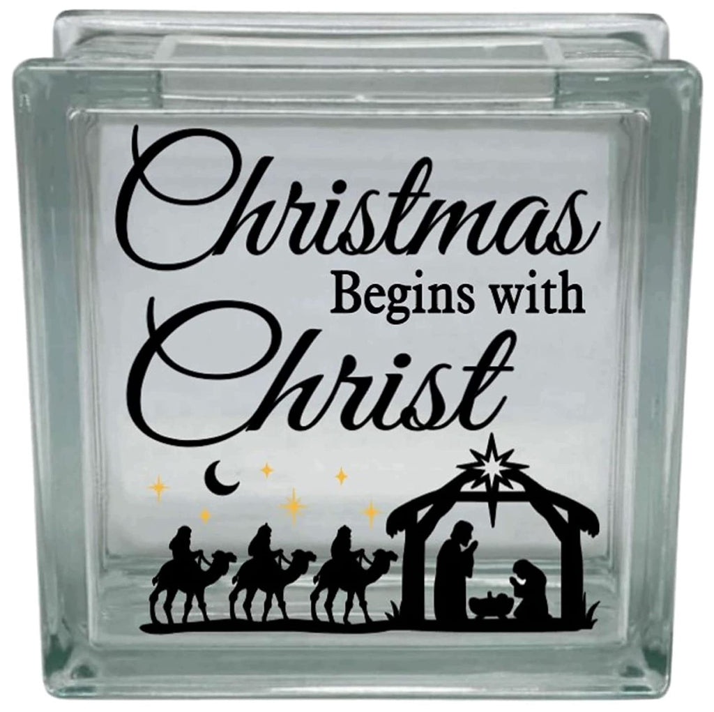 Glass block with Christmas design featuring nativity scene and text 'Christmas Begins with Christ'.