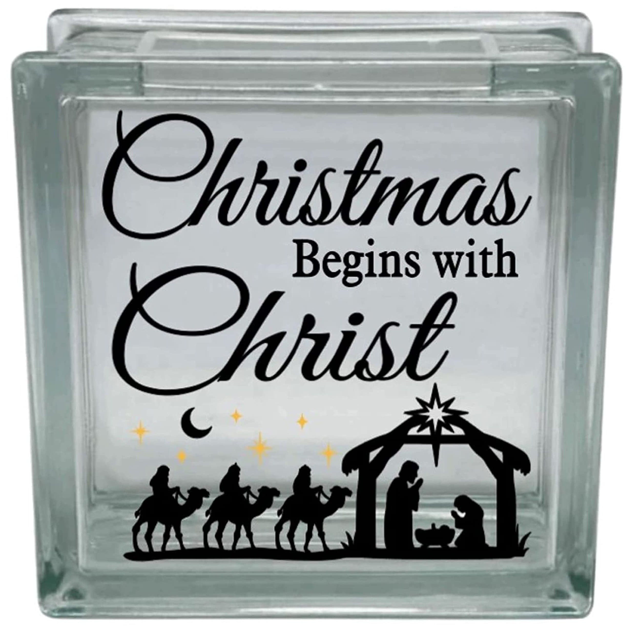 Glass block with Christmas design featuring nativity scene and text 'Christmas Begins with Christ'.
