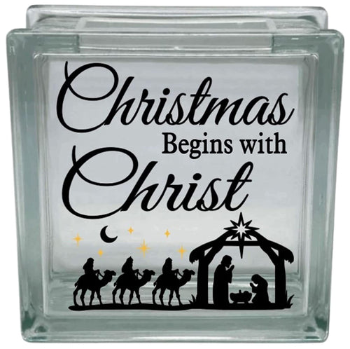Glass block with Christmas design featuring nativity scene and text 'Christmas Begins with Christ'.