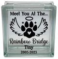 Glass block with paw print design and text 'Meet You At The Rainbow Bridge Tiny 2003-2023' on a white background