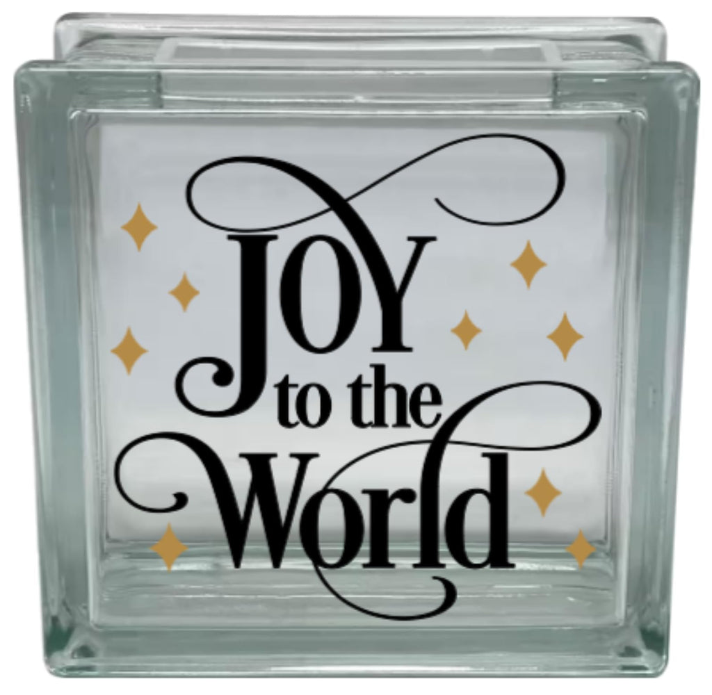 Glass block with 'Joy to the World' text and gold stars on a white background