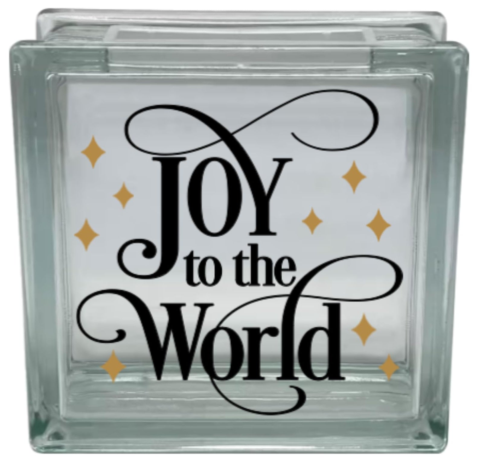 Glass block with 'Joy to the World' text and gold stars on a white background
