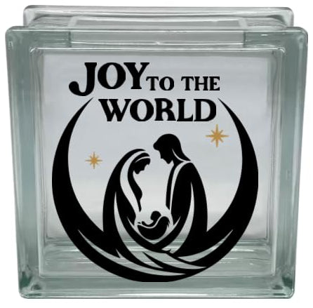 Glass block with 'Joy to the World' and nativity scene design on a white background